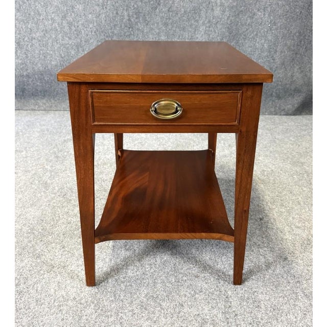This vintage Craftique end table, made in 1966, is crafted from solid mahogany and features a clean, timeless design with...