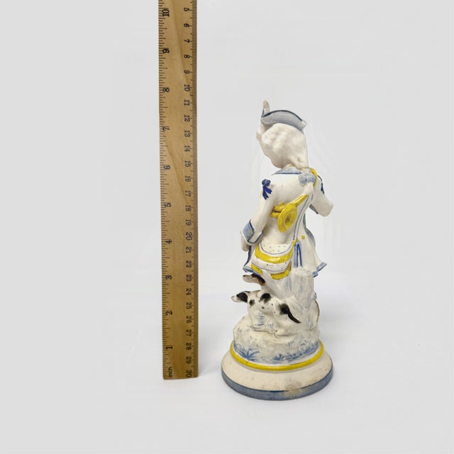 Capture the charm of classic European porcelain with this beautifully detailed figurine depicting a young hunter or...