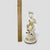 Capture the charm of classic European porcelain with this beautifully detailed figurine depicting a young hunter or...