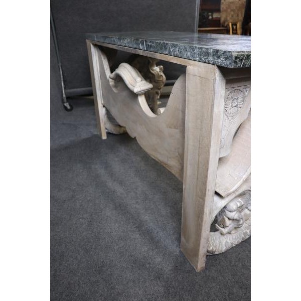 This monumental console table is a breathtaking work of art, featuring a richly veined Verdi marble top supported by...