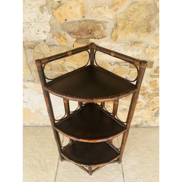 Vintage, mid-century, bamboo and rattan, three-tired corner shelf on legs, circa 1960s. this beautiful piece, has a design...