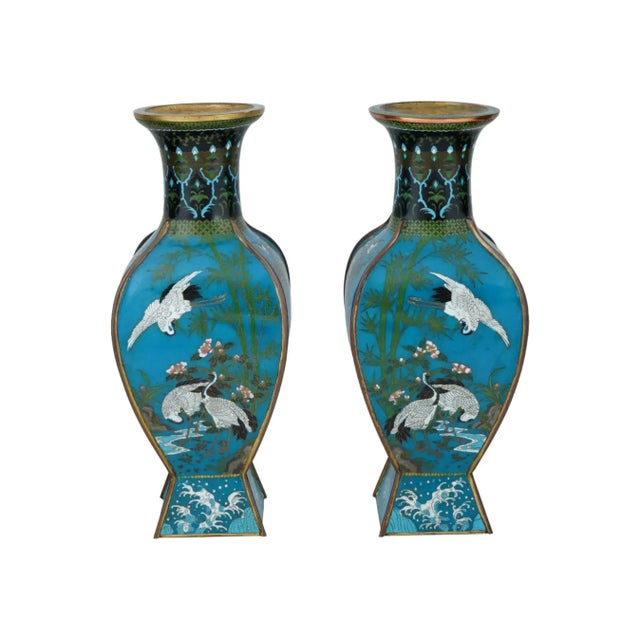 A pair of antique Japanese Meiji period facet cloisonne vases, featuring captivating bird motifs. Their substantial size...