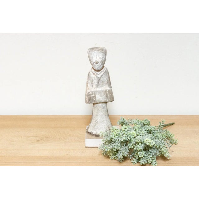 This captivating terracotta statue, crafted in the elegant style of the Han Dynasty, is a delightful representation of...