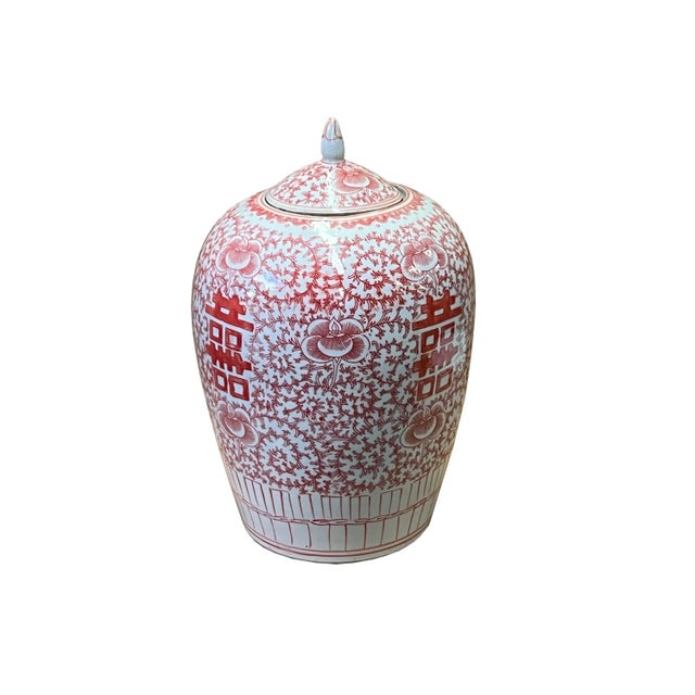 This is a handmade porcelain point lid jar with a white base and coral pink color graphic of floral & double happiness...