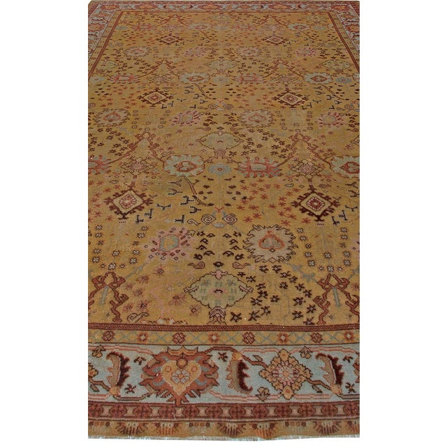 A magnificent example of early 20th-century Anatolian artistry, this 1920s Antique Turkish Oushak rug exudes the regal...