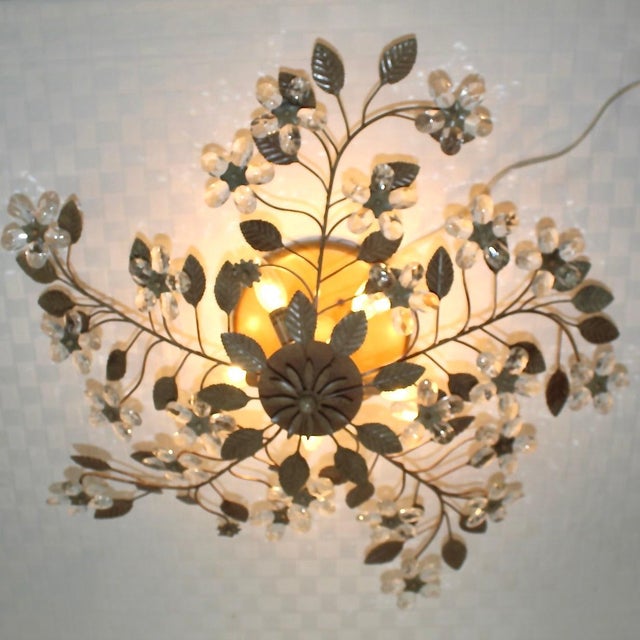 Large elegant, sophisticated ceiling fixture with crystal flowers and speckled tan painted metal leaves. Each faceted...