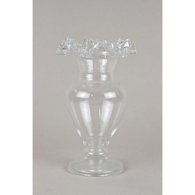 Extraordinary glass vase with frilly edge coming from the famous Art Nouveau period in Austria around 1900. The mouthblown...