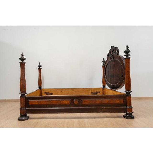 Spectacular antique bed with headboard and footboard made of carved hardwood. Large headboard with oval top carved with...