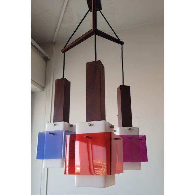 Guzzini "Bled" pendant light, designed by Luigi Massoni in 1962. This iconic mid-century lighting fixture features a...