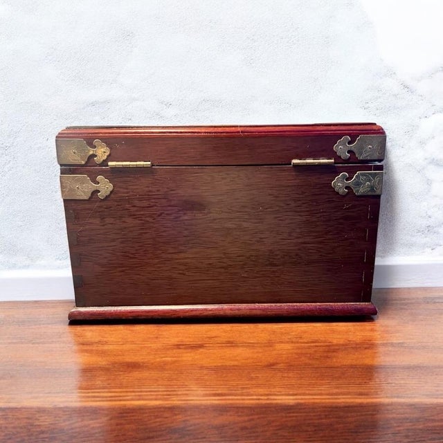 Add an air of elegance and cultural charm to your collection with this exquisite vintage Chinese rosewood jewelry box....