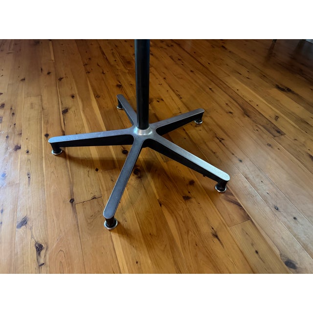 Vintage mid century modern dining table with Formica top by Herman Miller. Aluminum and black base. No sticker with makers...