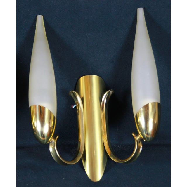 Angelo Lelli for the famous italian editor Arredoluce, pair of double sconces, in brass with frozen white glass, and...