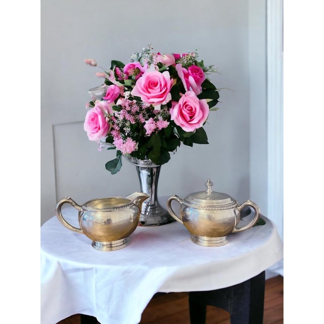 This is a beautiful silverplate creamer and sugar bowl with lid set by Oneida. Perfect for any special occasion or to use...