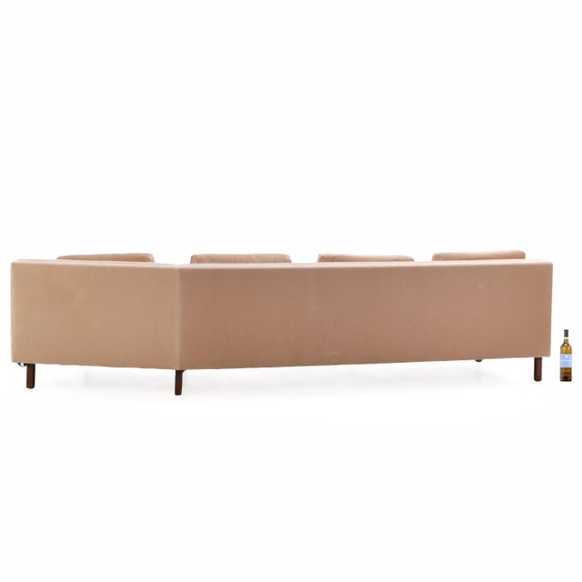 Featuring a camel-colored upholstered frame with a tufted seat, four matching loose back pillows, and short square legs. A...