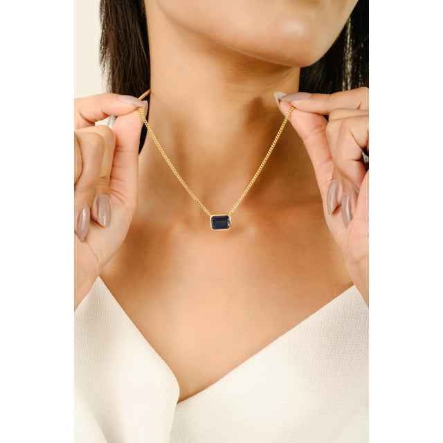 evate your everyday style with this Timeless 3.08 Ct Octagon Cut Blue Sapphire Pendant Necklace in 14K Yellow Gold...