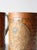 A pair of vintage copper-plated mugs with a hammered surface and embossed Aztec calendar medallions. The warm copper tone...