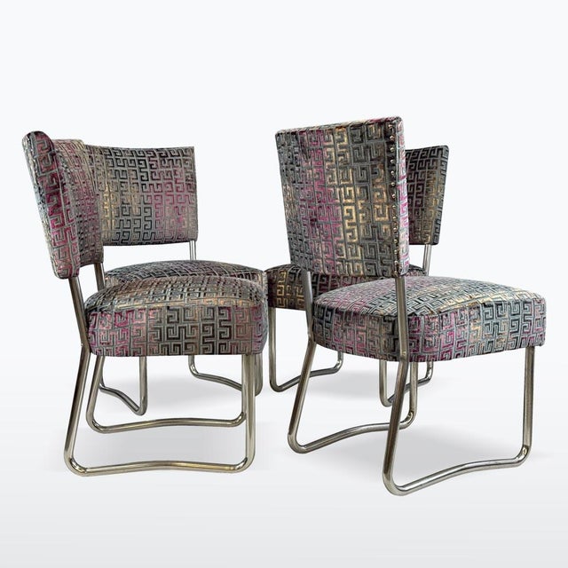 A stylish set of four tubular steel chairs from the 1930s in classic Bauhaus style. The chairs feature newly upholstered...