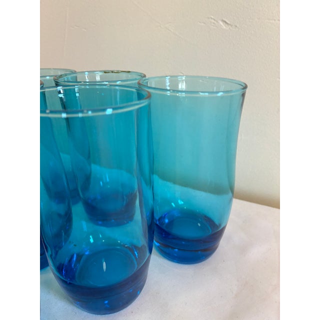 Set of six vintage aqua blue drinking glasses with a darker blue base. These retro tumblers have a clean, timeless shape...
