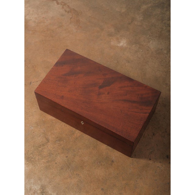 A refined vintage mahogany writing slope or lap desk box featuring classic proportions and handsome brass appointments....