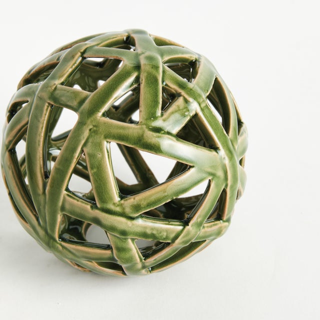 This contemporary little orb is made of thin ceramic strips giving it an open and airy feel. The dynamic, reactive glaze...