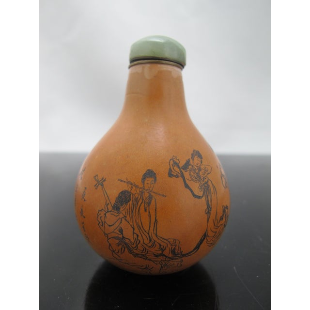 Antique, late 19th to early 20th century Chinese gourd snuff bottle. Hand etched figural design with script. Has metal rim...