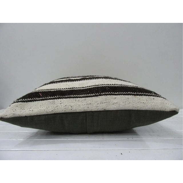 This is a pillow cover made from a vintage kilim rug. The piece was properly washed and ready to use. Pillow inserts not...