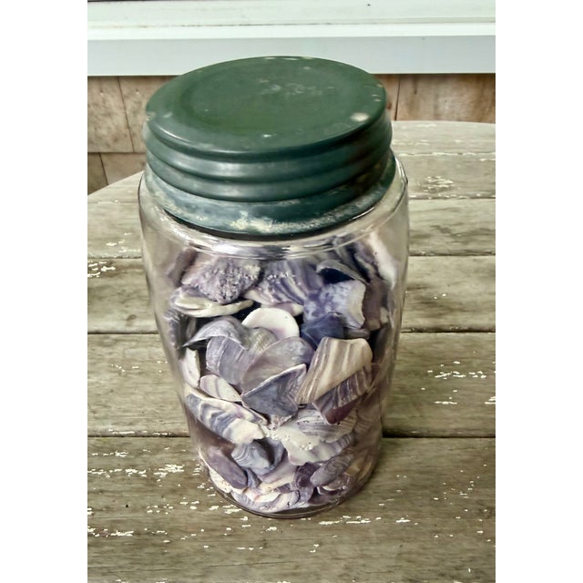 Antique unmarked quart Mason jar with zinc porcelain lined top and a very light touch of purple from manganese used in...