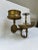 A single antique brass wall mounted articulating bathroom accessory holder including a tumbler or cup holder, toothbrush...