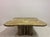 A sculptural marble coffee table from the 1970s, distinguished by its softly undulating square top and bold architectural...