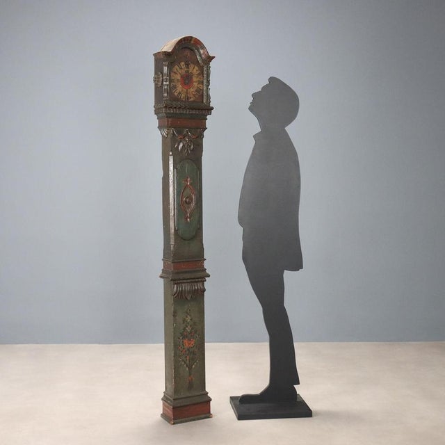 Grandfather clock. Lacquered fir wood case painted with floral motifs, leaf carvings, floral motifs, and festoons. Painted...