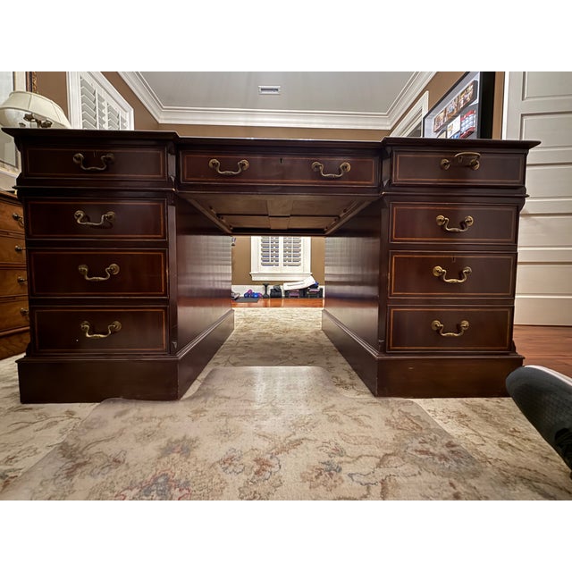 Vintage partners desk in a rich mahogany finish with leather insets on the top. There are a combination of drawer and...