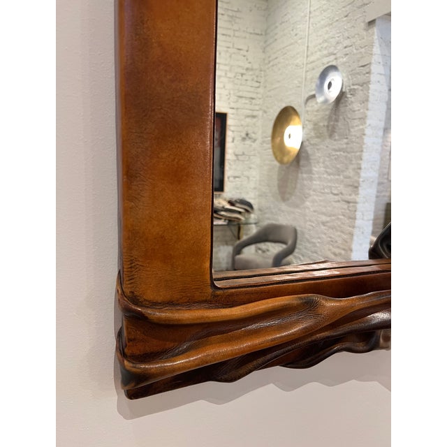 Gorgeous chestnut leather sculpted wall mirror. 1970s Poland.