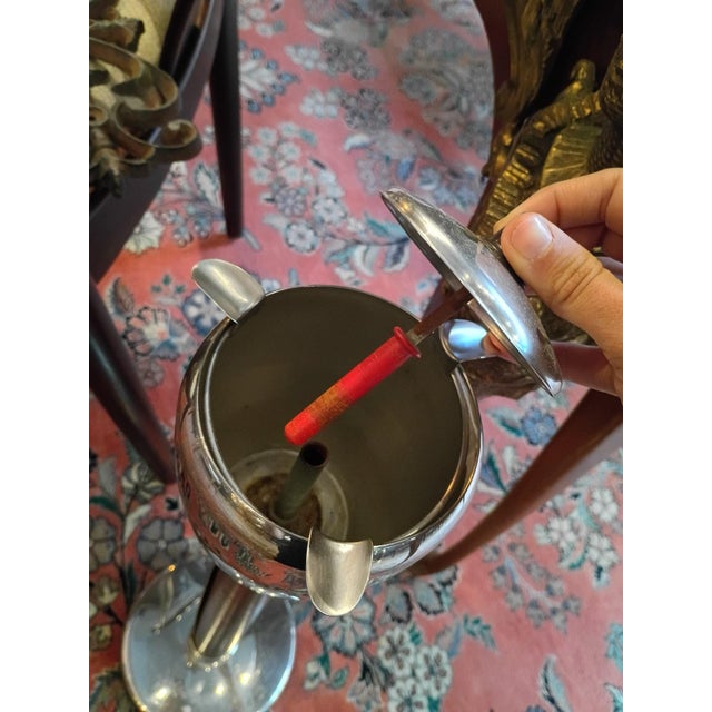 The vintage standing ashtray by BRA combines sleek stainless steel with rich leather detailing for a refined mid-century...