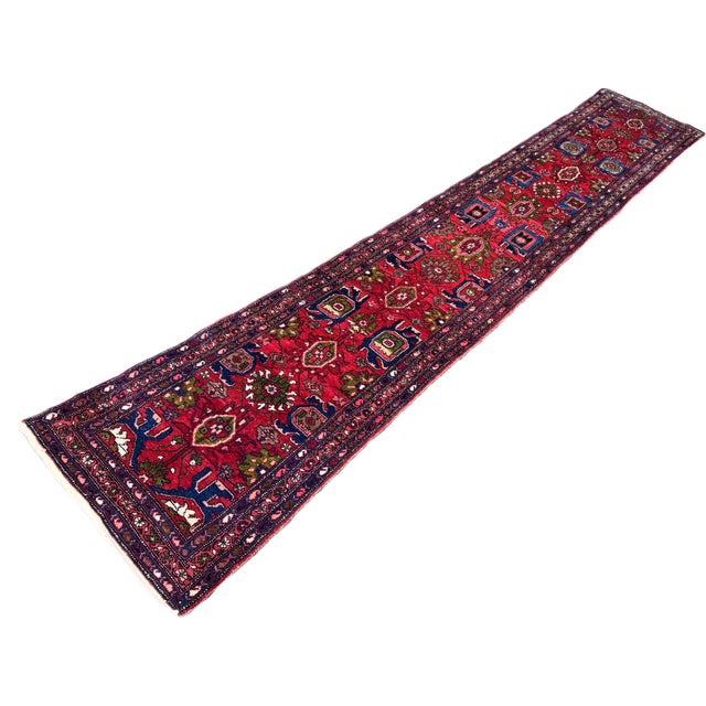 A beautiful antique runner, woven in one of the many villages surrounding Hamadan circa 1920. The runner features a...