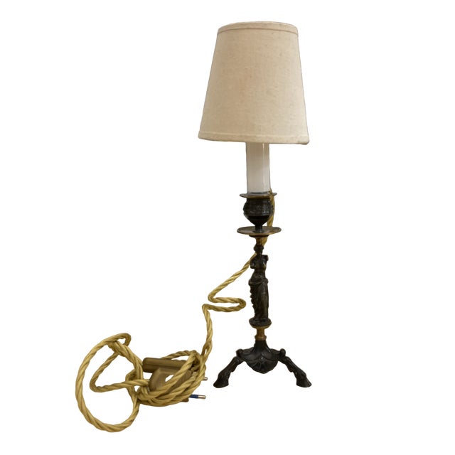 Pair of neoclassical lamps with sculptural bases in two different shapes, made of bronze. Each lamp has a neutral beige...