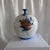 The John-Richard Yori Global Bazaar Pomegranate Motif Round Porcelain Vase is a decorative home accessory, often listed...