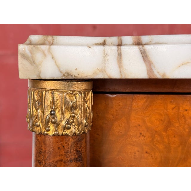 This antique c.1920's diminutive bowfront cabinet is a genuinely elegant small case piece, built around a burl veneered...