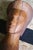 Wooden sculpture of a head on a pedestal. Carved wood that is probably teak or rosewood. Wonderful details. Sliver of wood...