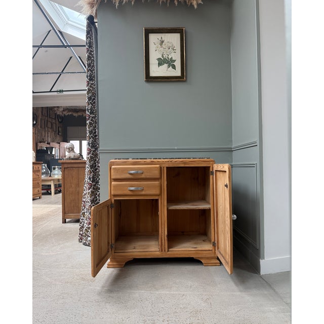This 1940s art deco sideboard is captivating with its clean lines, beautiful solid pitch pine grain, and marble top....