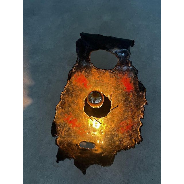 Designer unknown france 1960s h 38cm w 25cm d 17cm a one-of-a-kind sculptural wall lamp shaped by heat, texture and...