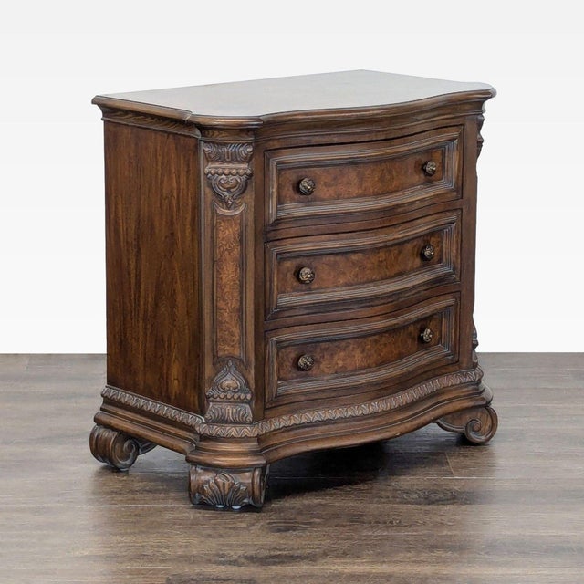 This walnut and burl veneer nightstand has a serpentine shaped top with burl crossbanding over the serpentine case of...