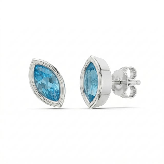 These elegant stud earrings feature vibrant Blue Topaz gemstones, admired for their refreshing sky-blue hue and...