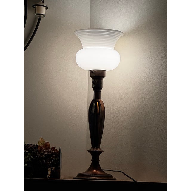 Elevate your space with this exceptional matching pair of vintage torchiere table lamps crafted by the renowned Colonial-...