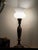 Elevate your space with this exceptional matching pair of vintage torchiere table lamps crafted by the renowned Colonial-...