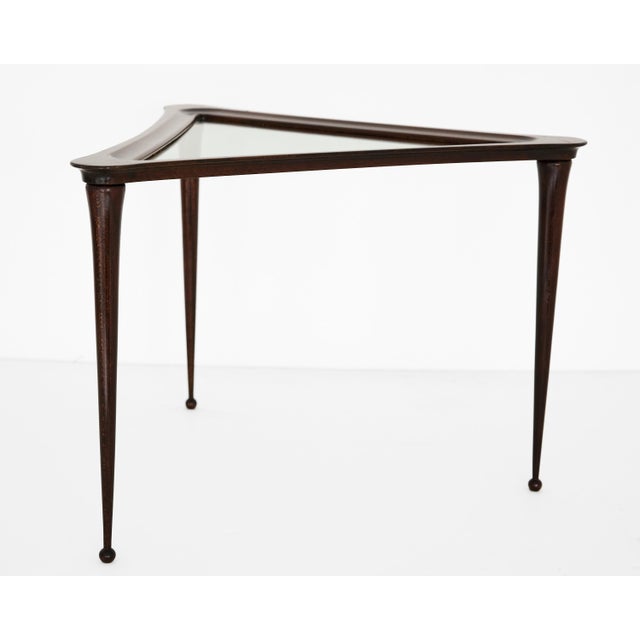 A striking example of postwar Italian design ingenuity, this triangular side table embodies the sculptural elegance that...