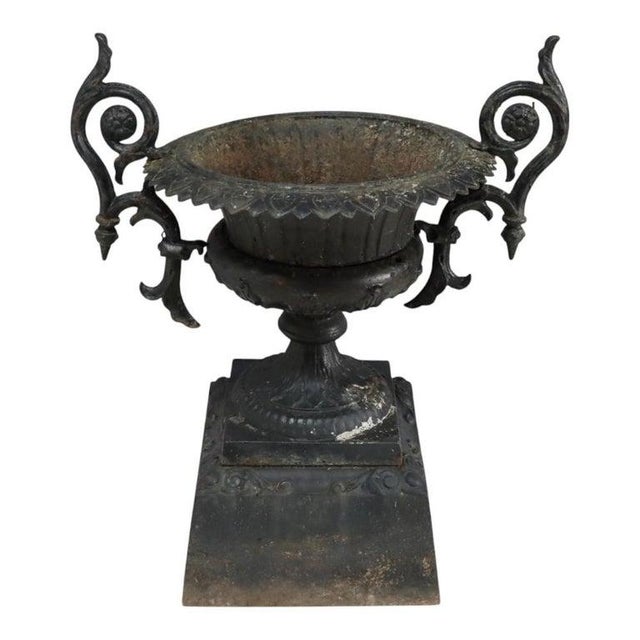 This antique cast iron garden urn, attributed to the renowned J.W. Fiske Iron Works, dates to approximately 1890. Crafted...