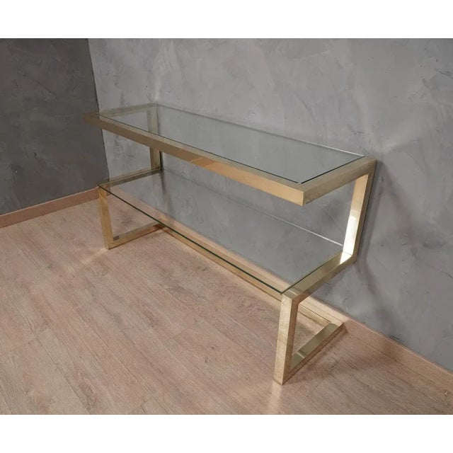 Pure Italian style for a console with an amazing design. The console is entirely structured with square brass tubes with a...