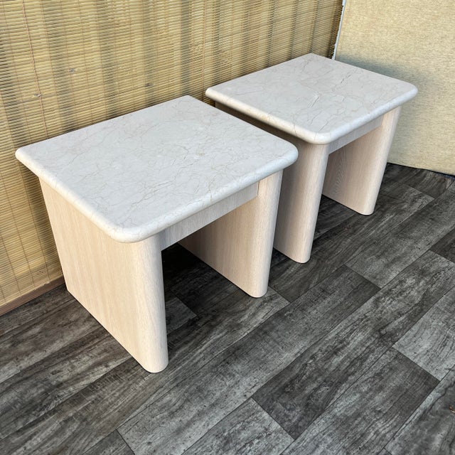 A Pair of Postmodern Custom-Made, Bull-Nose Marble Top Nightstands. Circa 1990s Features rounded-edge laminated bases, one...