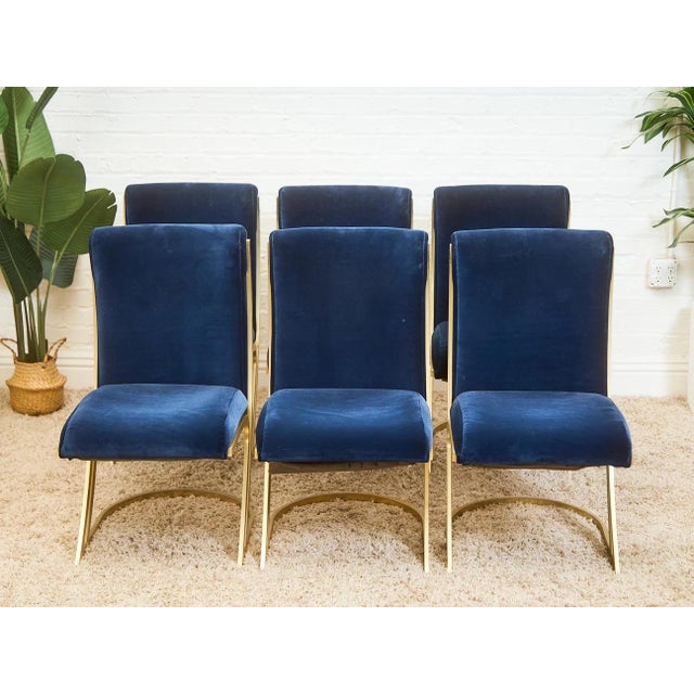 With its modern profile, natural wood legs, and stylish frame, this dining chair is sure to be an eye-catching piece for...