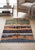 A hand-knotted rug in the Persian Gabbeh style, woven as a layered landscape in sage green, gold, indigo and cream. Hand-...